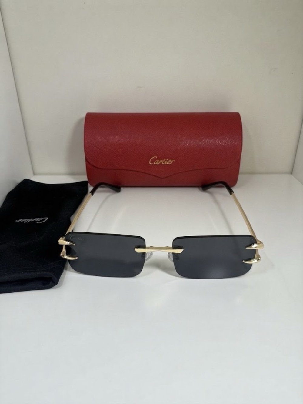 Cartier Gold Rimless Sunglasses for men with Black Lenses and Red Case